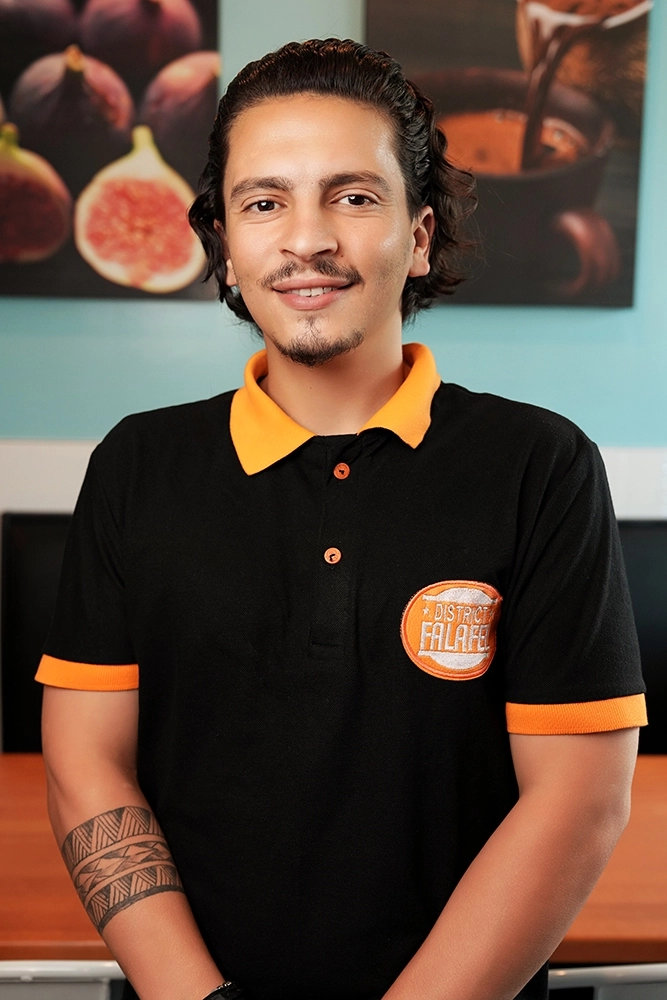 Profile headshot of a male employee at District Falafel