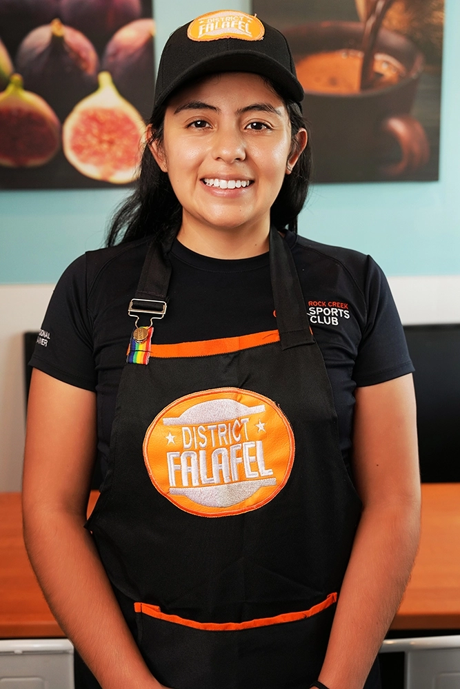 Profile headshot of a female employee at District Falafel