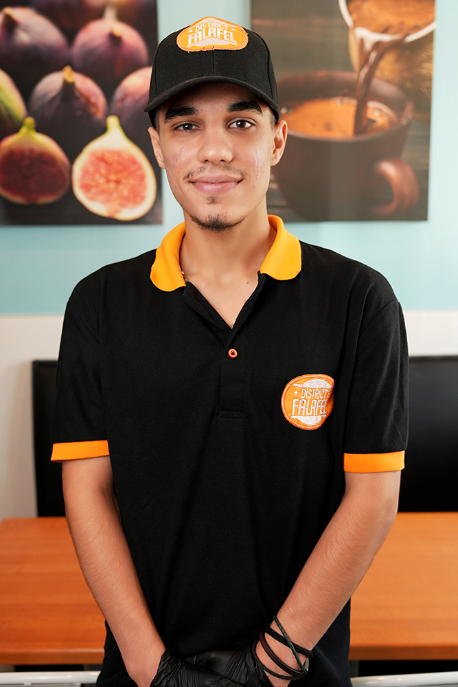 Profile headshot of a male employee at District Falafel