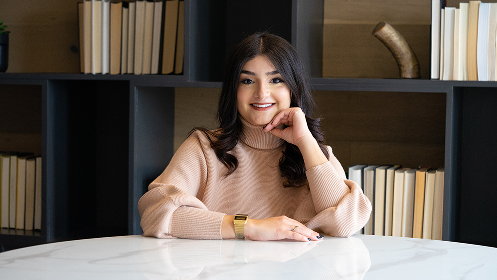 Luxury Real Estate Agent sitting at the table posing elegantly in a luxury home