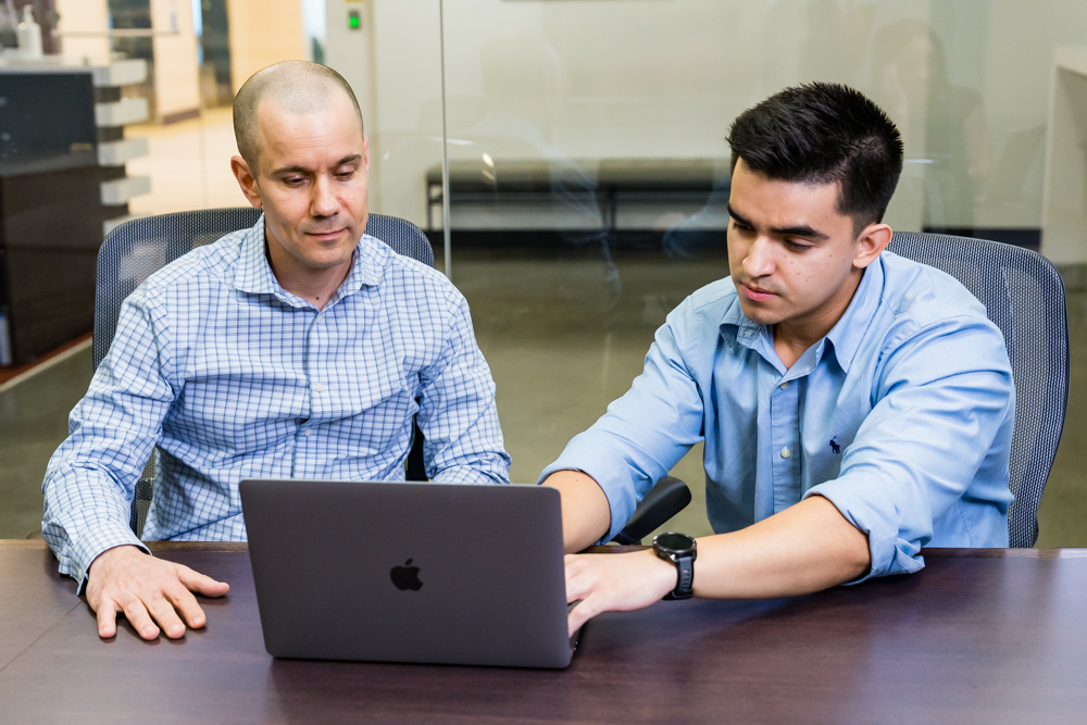 Two Men In A Meeting Review Computer