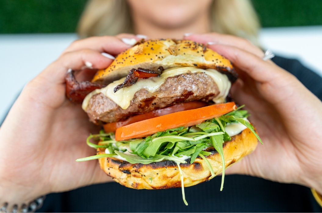 Fast Casual Restaurant Marketing Photo Woman Holding A Hamburger