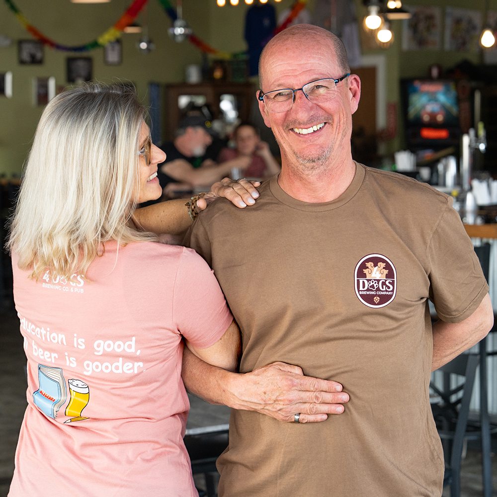 Bar Owner With Friend In Brew Pub Smiling
